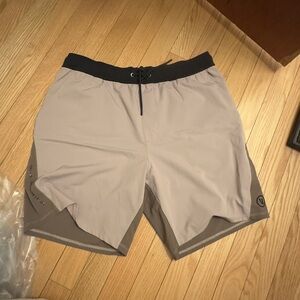 Vuori Men's Athletic Shorts in Tan and Black KORE chromatic